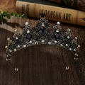 Detailed macro view of a vintage gold crown with black crystals on a dark wood table - Antique Gold + Black Rhinestone