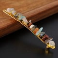 Close-up of natural colorful crystal chips secured by gold wire on a metal hair clip - Mixed Stones + Gold Clip
