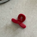 Detail view of a glossy red acetate hair claw clip with handmade gold lettering - Red (Mini Cross)