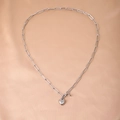 Macro shot of silver heart pendant and textured paperclip chain on soft satin background - Necklace / Silver