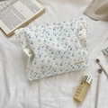 Macro view of floral pattern and white lace detail on a large capacity cosmetic bag - Jacquard Blue Cherry