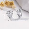 Macro shot of silver pear-shaped zircon earrings with 10mm x 7mm size labels - EH765 Teardrop Vintage Studs