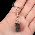 Handheld square grey natural stone keychain with red and green spots on silver metal chain - African Blood Stone