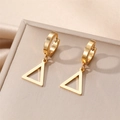 Macro shot of gold geometric triangle pendant earrings on a beige display board - Hollow Triangle