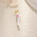 Macro shot of white enamel chili pendant with gold accents and pink star detail - White with Stars