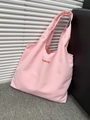 Detailed texture of pink canvas tote bag featuring red Simplicity embroidery stitching - Light Pink