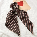 Elegant black satin scrunchie with red and beige stripes featuring a long ribbon streamer - Black Stripe