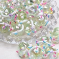 Macro shot of iridescent pale yellow glass beads with colorful sugar sprinkles for DIY crafts - 18mm / Light Green Bead + Colorful Sprinkles