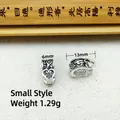 Detailed view of silver ethnic charm with engraved patterns and heart cutout, 13mm size - Small