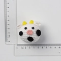 Handmade crochet cow keychain in white and black yarn, size 4cm on white background - Cow Head Doll
