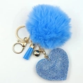Detailed shot of a blue pompom keychain with a rhinestone heart and golden hardware - Sky Blue
