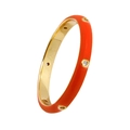 Detail of gold-plated copper ring featuring orange enamel and inset white crystals - Orange