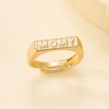 Detailed view of a gold-plated adjustable ring with a MOMY relief on a white background - MOMY Letter Open Ring (N-312)