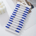 Close-up of 12-piece blue and white clay bead bracelets with CHEER letter beads - 12 Pieces / Dark Blue