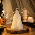 Ghost-shaped white scented candle on wooden base with festive pumpkin background - Mystery Man (White)