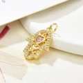 Detail of gold Hamsa pendant featuring a pink heart stone and clear zircon accents - Pink Zirconia