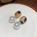 Detail view of gold leopard print earrings with pearls on a striped ceramic dish - 22# Pearl Leopard Gold Earrings (Silver Earring Post-Gold-Coffee-White)