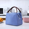 Insulated lunch bag with classic blue and white stripes and brown fabric handles - Blue