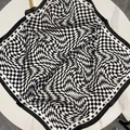 Black and white optical illusion checkered silk scarf displayed on marble background - 70-215 Black