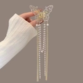Close-up of golden butterfly hair claw with pearl tassels and shimmering rhinestones - Hollow Butterfly 4 Tassels