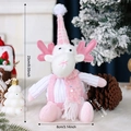 Pink reindeer plush gnome with knitted hat and sequins in a cozy Christmas setting - Pink White Sphere Elk
