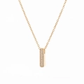 Detailed close-up of a golden rectangular pendant necklace with white zircon pavé setting - Letter I