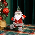 Detail of plush Santa Claus ornament hanging on Christmas tree with snowflake button - New Dancing Santa