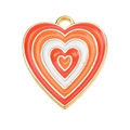 Detailed view of layered red and orange enamel heart pendant with golden alloy frame - Red Orange White