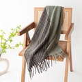 Plaid knitted scarf in green and dark brown with fringe on a wooden chair - Bean Green