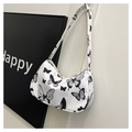 Detail shot of underarm bag featuring white fabric with black butterfly print textures - Butterfly