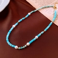 Detail of beaded necklace with light blue beads, white pearls and golden lobster clasp - Sky Blue Transparent Bead Splicing / Gold-Blue