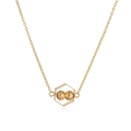 Close-up of golden necklace with hexagonal geometric pendant and faceted double beads - Hexagonal Geometric Pendant