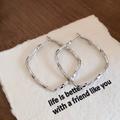 Detail of silver twisted square hoop earrings on card with emotional quote text - Silver Rhombus Hoop (53#)