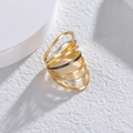 Close-up of a multilayered geometric ring with gold, silver, and black matte finish - Three Colors