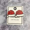 Festive red and white Christmas hat earrings on fashion card with marble background - Christmas Hat
