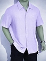 Detailed macro shot of purple short-sleeve shirt showing waffle texture and collar - Light Purple