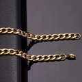 Macro shot of gold stainless steel Cuban chain link on a textured black leather background - Gold [6.0mm Width] / Length [45CM]