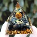 Orgone pyramid with tiger eye sphere, obsidian, and Buddha icon in resin finish - Tiger Eye Ball Buddha / Small