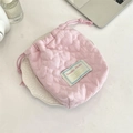 Close-up of pink heart quilted drawstring camera pouch on a white ceramic saucer - Crinkle Heart Light Pink