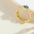 Adjustable golden ring featuring pink enamel band and blue evil eye charm detail - Hexagram Enameled (JZ0388-6)