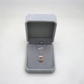 Octagonal grey velvet jewelry box with rose gold crown pendant and sparkling necklace - Gray