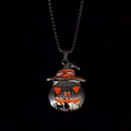 Macro shot of Halloween pumpkin wizard pendant with orange accents and steel chain - Orange