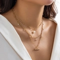 Detail of layered gold necklace with white pearls and sparkling crystal pendants - Gold-Pearl T-Bar Pendant