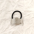 Black elastic hair tie featuring a silver hammered metal oval ornament in minimalist style - Silver Pitted Texture 5cm