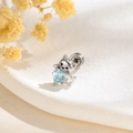 Silver cat stud earring holding a light blue heart zircon on a clean white background - Single Piece / Silver Cat with Light Blue Heart Stone (A937-3)