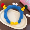 Dettaglio fascia per capelli in peluche blu con occhi 3D e decorazioni a spirale - Stile Divertente Con Occhi Grandi / Blu