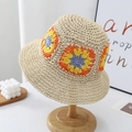 Beige hand-crocheted bucket hat with colorful flower patterns on a wooden stand - One Size / Beige