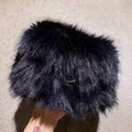 Detailed close-up of soft navy blue faux fur texture with a small metal ring attachment - Black