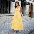 Elegant bright yellow tiered maxi dress with deep V-neck and decorative sun brooch - S / Yellow