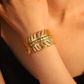 Elegant wide adjustable gold fern leaf cuff bracelet with embossed beads on wrist - Dotted Leaf